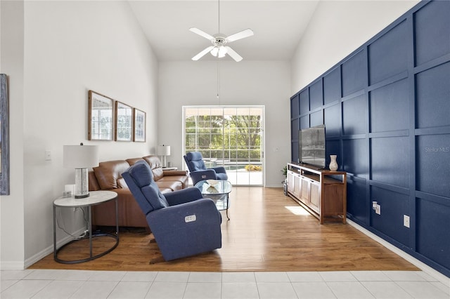 551 Wheatstone Pl, Orlando, FL 32835 - living room with light wood-style flooring, a high ceiling, baseboards, and ceiling fan