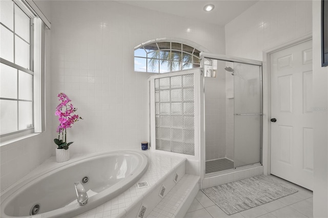 551 Wheatstone Pl, Orlando, FL 32835 - full bathroom with tile patterned flooring, a jetted tub, and a stall shower