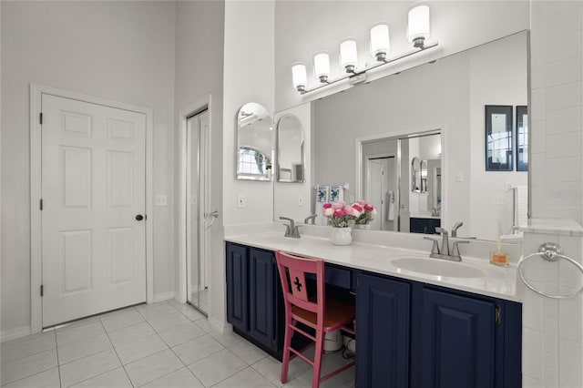 551 Wheatstone Pl, Orlando, FL 32835 - bathroom with tile patterned floors, double vanity, and a sink