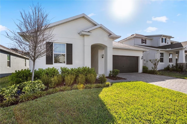 4418 Lions Gate Ave, Clermont, FL 34711 - view of front of house featuring stucco siding, a garage, driveway, and a front lawn