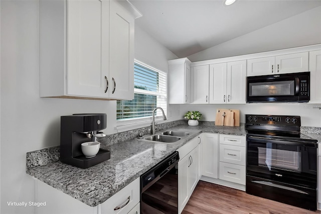 16171 SW 44th Cir, Ocala, FL 34473 - kitchen featuring black appliances, a sink, vaulted ceiling, white cabinetry, and light stone counters
