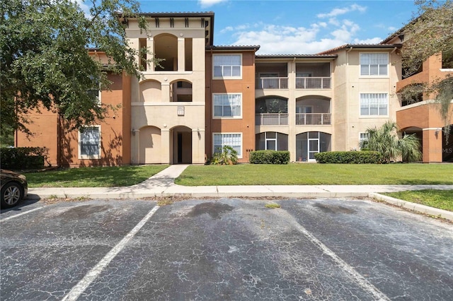 view of property with uncovered parking