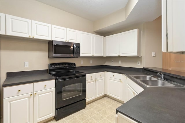 kitchen with dark countertops, stainless steel microwave, black electric range oven, white cabinetry, and a sink