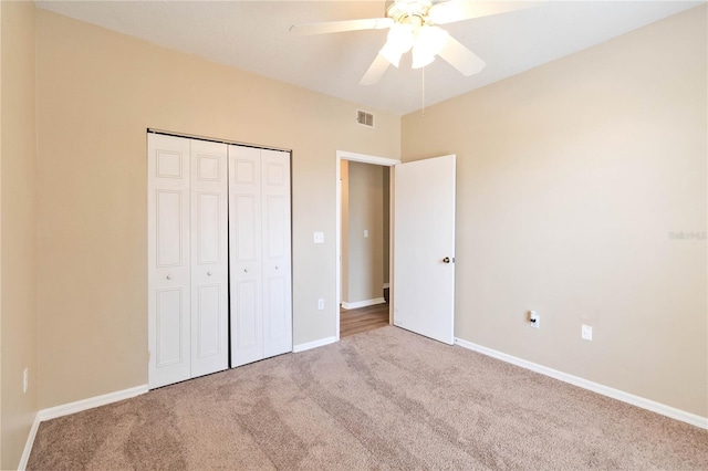 unfurnished bedroom featuring a closet, visible vents, baseboards, and carpet floors