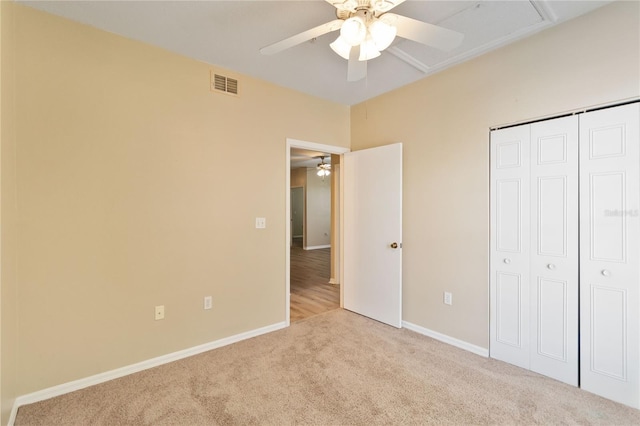 unfurnished bedroom with visible vents, baseboards, ceiling fan, carpet flooring, and a closet