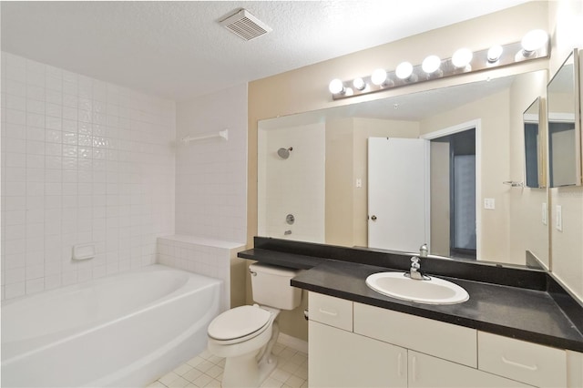 bathroom featuring vanity, visible vents, tile patterned flooring, a textured ceiling, and toilet