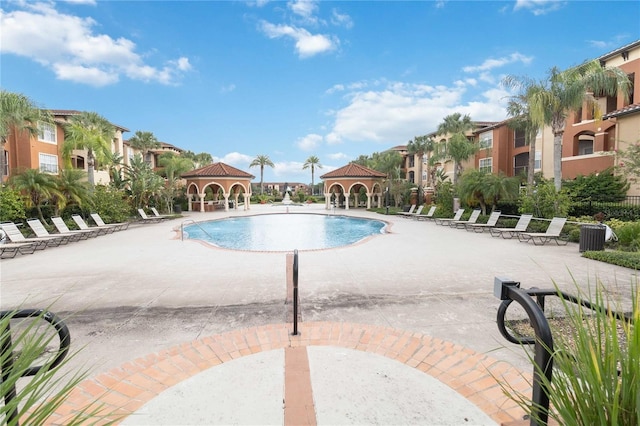 community pool featuring a patio area and fence