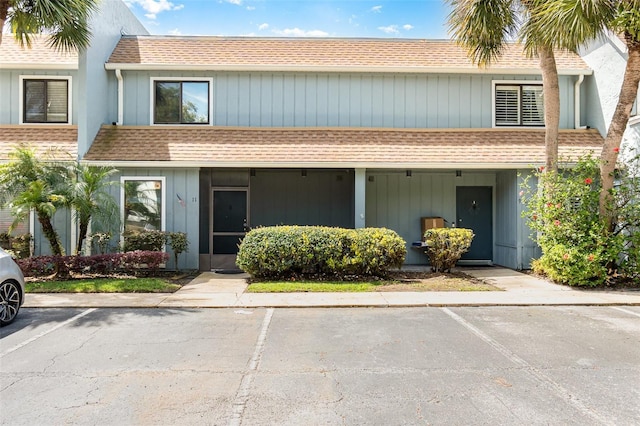 40 Moree Loop Unit 11, Winter Springs, FL 32708 - multi unit property featuring roof with shingles and uncovered parking