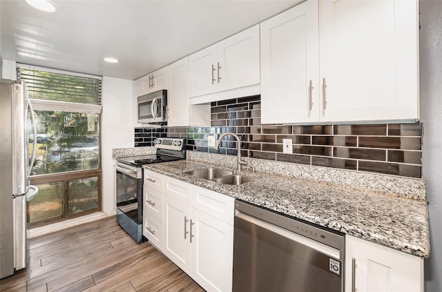 40 Moree Loop Unit 11, Winter Springs, FL 32708 - kitchen featuring stainless steel appliances, a sink, white cabinetry, and recessed lighting