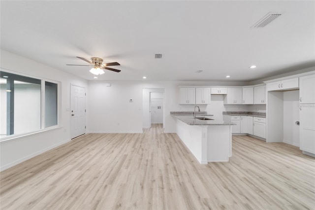 23741 SW Blueberry Ln, Dunnellon, FL 34431 - kitchen with recessed lighting, white cabinetry, stone counters, ceiling fan, and light wood finished floors