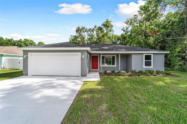 23741 SW Blueberry Ln, Dunnellon, FL 34431 - ranch-style house featuring a garage, concrete driveway, stucco siding, and a front yard