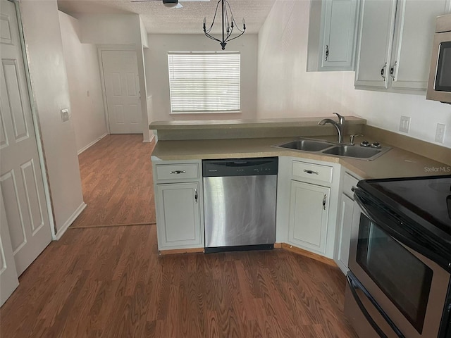 5417 Lake Margaret Dr Unit 39, Orlando, FL 32812 - kitchen with a sink, a textured ceiling, dark wood finished floors, appliances with stainless steel finishes, and light countertops