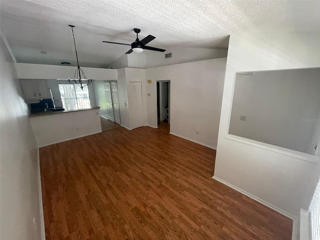 5417 Lake Margaret Dr Unit 39, Orlando, FL 32812 - unfurnished living room featuring baseboards, a textured ceiling, wood finished floors, and ceiling fan with notable chandelier
