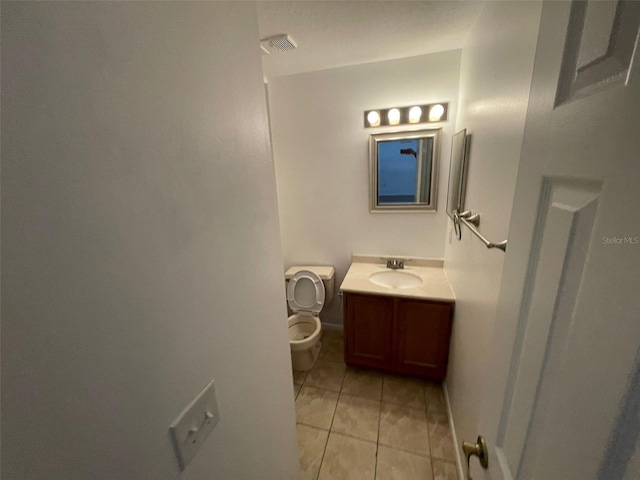 5417 Lake Margaret Dr Unit 39, Orlando, FL 32812 - bathroom with vanity, baseboards, visible vents, tile patterned flooring, and toilet