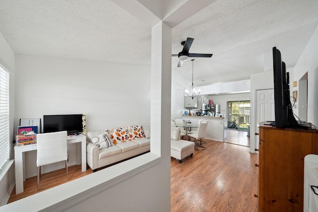 5417 Lake Margaret Dr Unit 39, Orlando, FL 32812 - living area with a ceiling fan, wood finished floors, a textured ceiling, a chandelier, and a desk