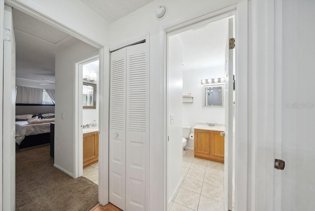 5417 Lake Margaret Dr Unit 39, Orlando, FL 32812 - hall with light tile patterned floors and a sink