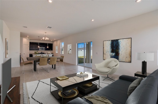 living area featuring light tile patterned floors, visible vents, a chandelier, and recessed lighting
