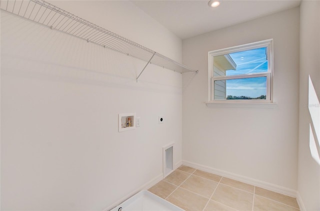 laundry room featuring baseboards, laundry area, light tile patterned flooring, electric dryer hookup, and washer hookup