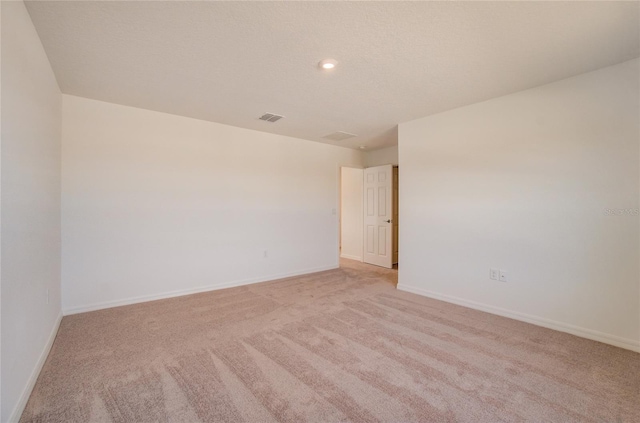 spare room featuring recessed lighting, visible vents, baseboards, and light colored carpet
