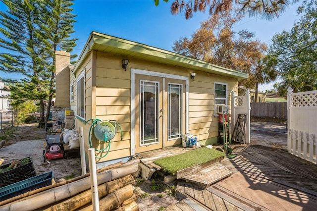 5224 29th Ave S, Gulfport, FL 33707 - exterior space with cooling unit, french doors, a chimney, and fence