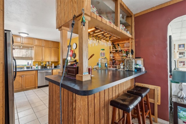 5224 29th Ave S, Gulfport, FL 33707 - bar with light tile patterned floors, stainless steel appliances, and indoor bar