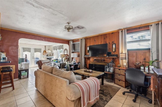 5224 29th Ave S, Gulfport, FL 33707 - living area with visible vents, a textured ceiling, light tile patterned flooring, and a ceiling fan