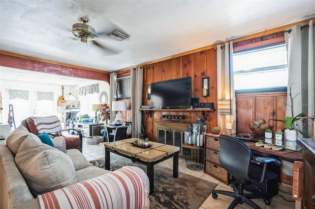 5224 29th Ave S, Gulfport, FL 33707 - tiled living area with visible vents, wooden walls, a textured ceiling, and a ceiling fan