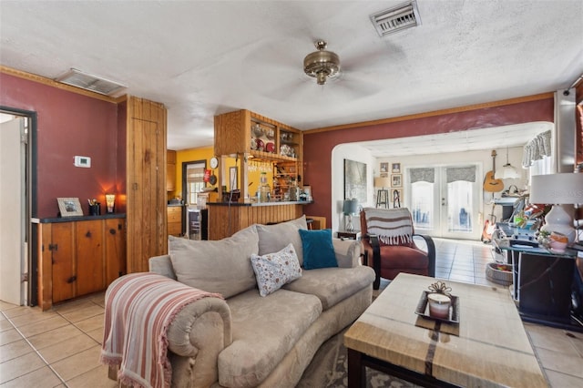 5224 29th Ave S, Gulfport, FL 33707 - living room featuring light tile patterned floors, visible vents, french doors, and a ceiling fan