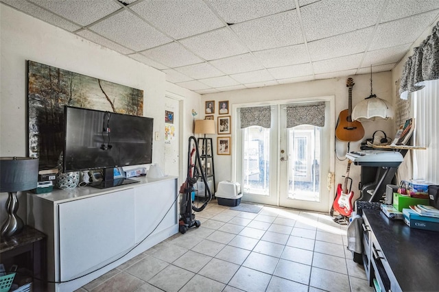 5224 29th Ave S, Gulfport, FL 33707 - living room with light tile patterned floors, french doors, and a paneled ceiling