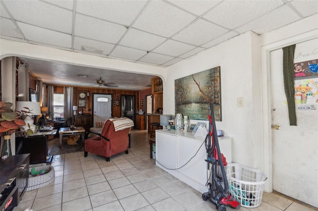5224 29th Ave S, Gulfport, FL 33707 - living room featuring light tile patterned floors, a drop ceiling, arched walkways, and ceiling fan