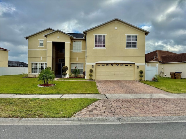 traditional-style home with fence, an attached garage, stucco siding, a front lawn, and decorative driveway