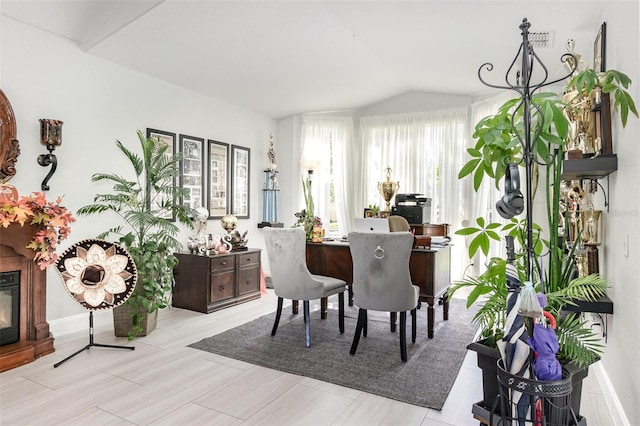 3244 Amaca Cir, Orlando, FL 32837 - dining space featuring a glass covered fireplace and lofted ceiling