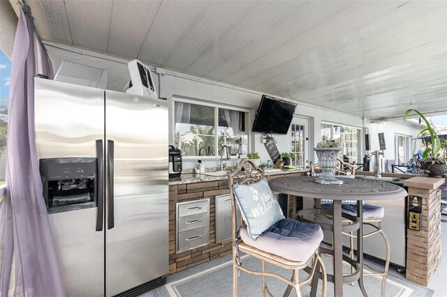 3244 Amaca Cir, Orlando, FL 32837 - kitchen featuring stainless steel fridge with ice dispenser, a sink, and wood ceiling