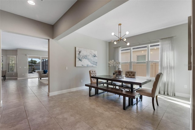 dining room with light tile patterned floors, baseboards, and an inviting chandelier