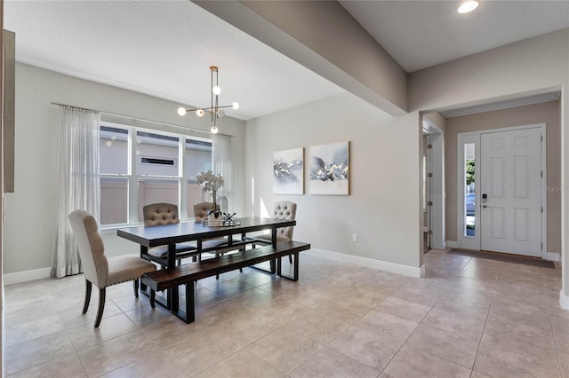 dining space featuring light tile patterned floors, baseboards, and a notable chandelier