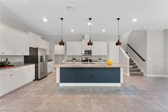kitchen featuring visible vents, appliances with stainless steel finishes, and white cabinetry