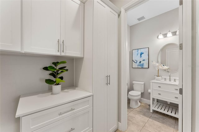 bathroom featuring tile patterned floors, visible vents, toilet, baseboards, and vanity
