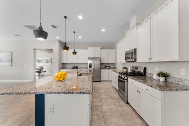kitchen with light tile patterned floors, recessed lighting, a sink, stainless steel appliances, and white cabinetry