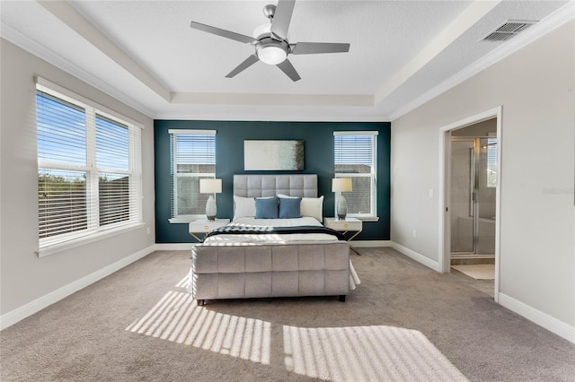 bedroom with baseboards, visible vents, a raised ceiling, and carpet floors