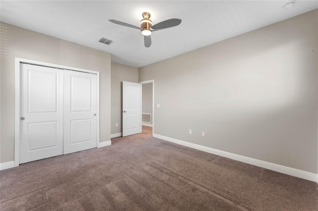 unfurnished bedroom featuring visible vents, carpet floors, and a closet