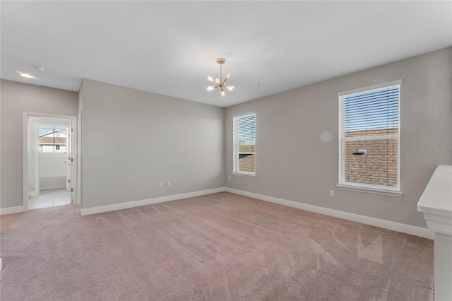 unfurnished room with light carpet, plenty of natural light, and baseboards
