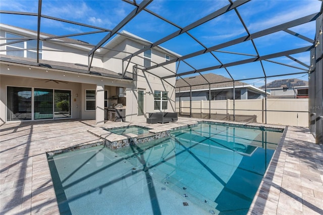 view of swimming pool with ceiling fan, glass enclosure, and a patio