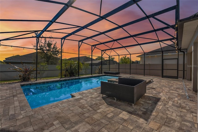 view of swimming pool featuring a patio, a fenced backyard, a fenced in pool, and a lanai