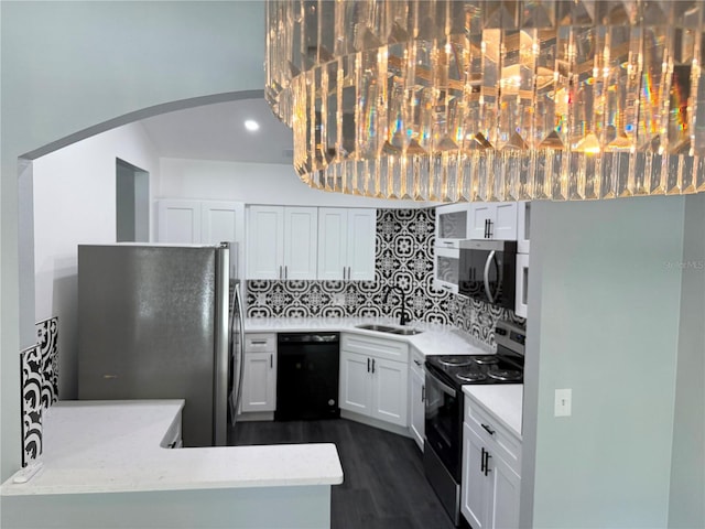 1010 Loch Vail Unit 1125, Apopka, FL 32712 - kitchen with appliances with stainless steel finishes, a sink, backsplash, arched walkways, and dark wood-type flooring