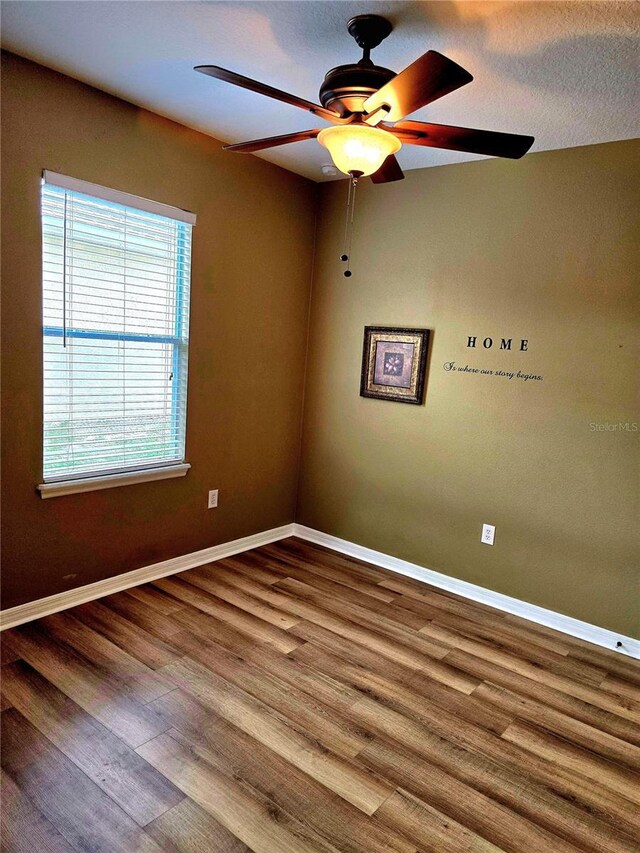 25012 Chipshot Ct, Sorrento, FL 32776 - empty room featuring baseboards, ceiling fan, and wood finished floors