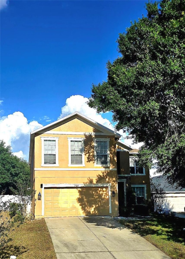 25012 Chipshot Ct, Sorrento, FL 32776 - traditional home with stucco siding, driveway, and an attached garage