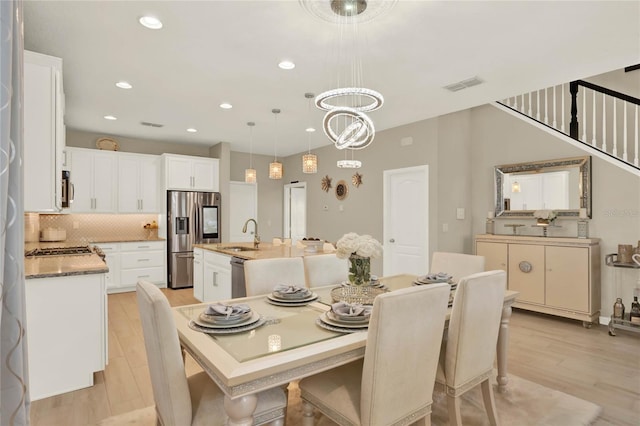dining room featuring a notable chandelier, recessed lighting, visible vents, and light wood finished floors