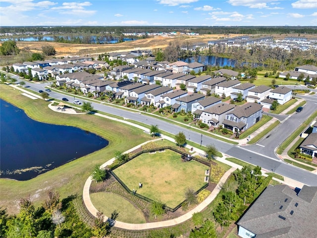 drone / aerial view with a residential view and a water view
