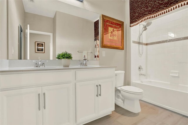 full bath featuring double vanity, toilet,  shower combination, and a sink