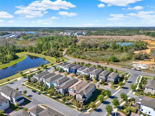 drone / aerial view with a residential view and a water view